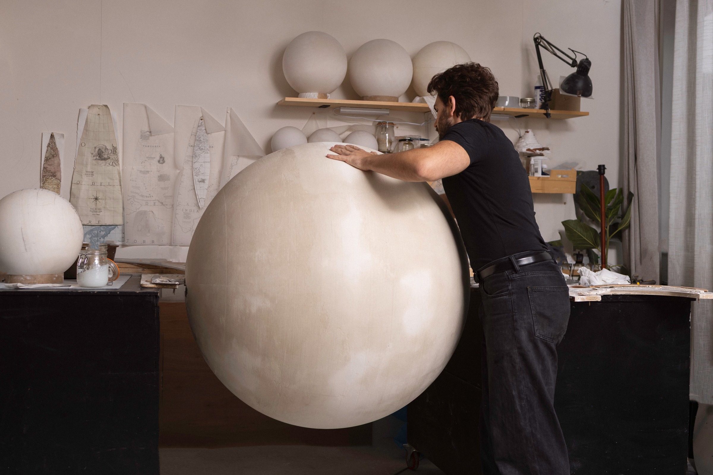 Leonardo Frigo working on the plaster sphere, constellation gores laid out on the wall